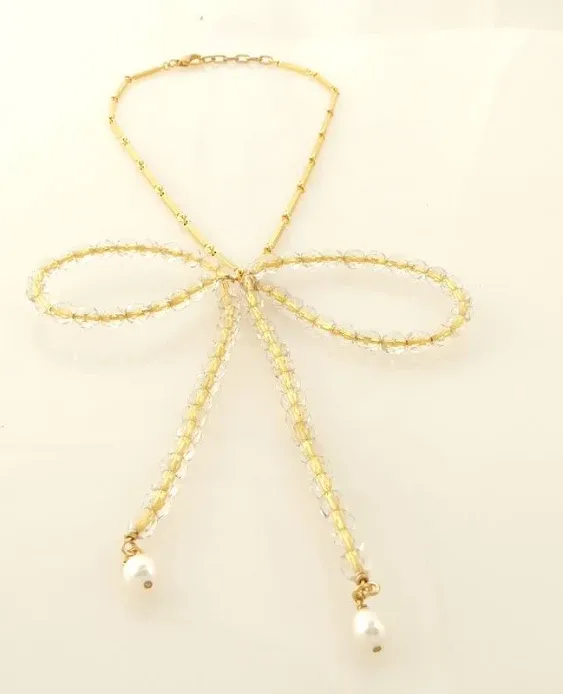 Golden beaded bow necklace