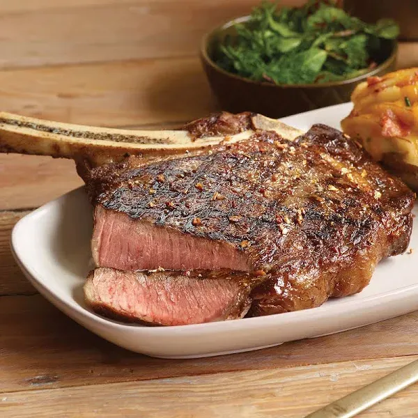 Premium French-cut Bone-in Ribeye Steak, 4 pieces, 22 oz each - Wet Aged for Perfection with Included Cooking Instructions - A Culinary Delight for Every Occasion from Kansas City Steak Company.